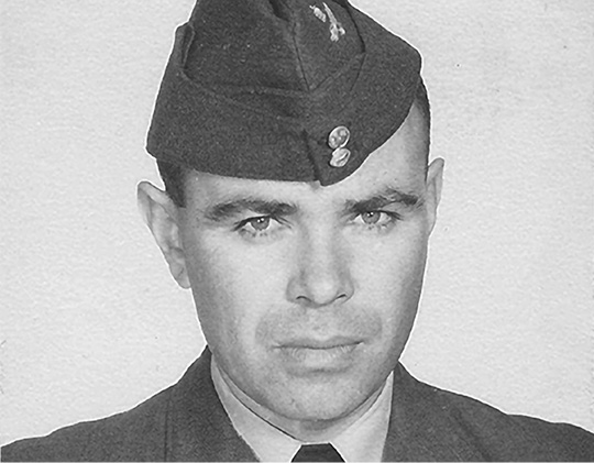 Black and white photograph: Formal head shot of an Indigenous man dressed in a RCAF military uniform.  He is approximately 33 years of age. 