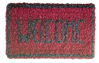 Photo: red welcome mat with a grey border and grey lettering in all caps spelling out, “Welcome.”