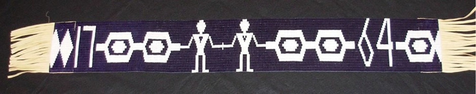 Colour illustration. A wampum belt with a purple background, with white hexagons in a chain connected to two figures in the middle holding hands. The hearts of the two figures are indicated. The numbers 17 and 64 are on the left and right of the belt.