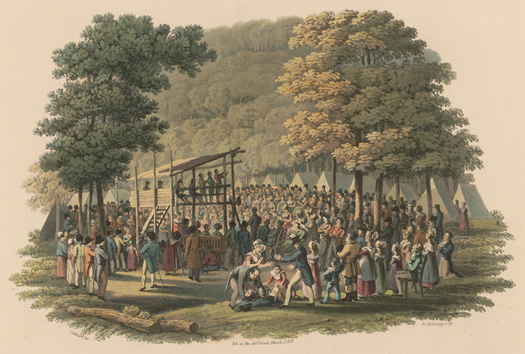 Colour painting. A large crowd of people in colourful early nineteenth century dress are standing in a forest. There is a wooden platform in the centre, with some people speaking from it. There is a large row of tents behind the crowd.