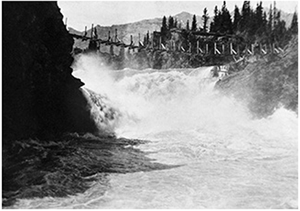 Kananaskis Falls looking upstream. A dam is in the background.