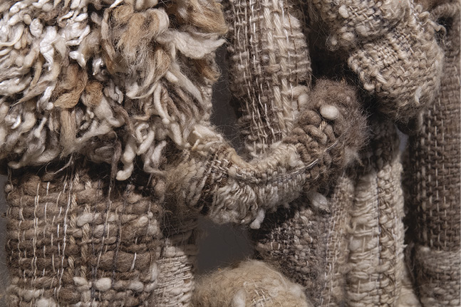 Photo: detail of the previous image showing the brown strings and the woven bits.