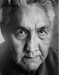Black and white photograph: Portrait of a man looking intensely into the camera.