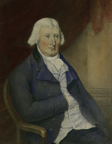 Colour painting. Portrait of a white man, sitting on a chair. He is wearing a blue overcoat and a striped, white collared shirt. He has mid-length white hair that covers his ears, and his right hand is tucked into his waistcoat.