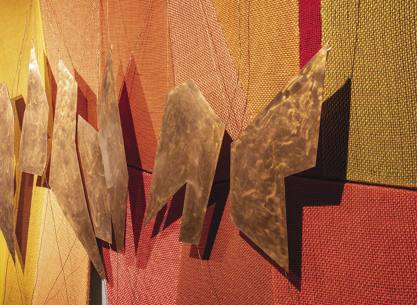 Photo: zoomed in details of the jagged copper against the red and orange panels from the previous image.