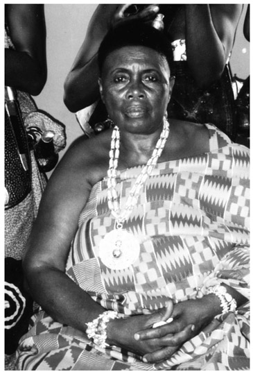 A black and white photograph of Queenmother of Wenchi, sitting on a chair.