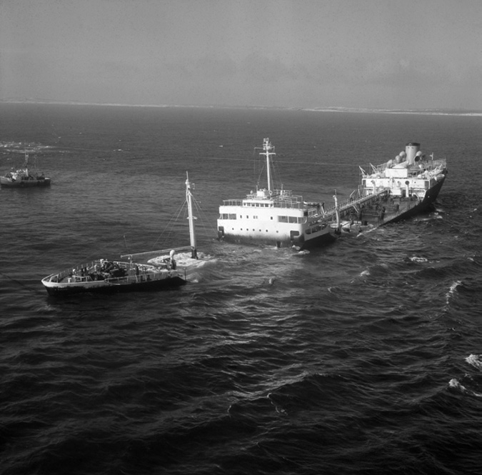 The Arrow, a tanker chartered by Imperial Oil, sank in a storm off the Nova Scotia coast in 1970, requiring a massive cleanup from the oil spill. This photo shows the Arrow foundering and sinking slowly several days after the crew was rescued from the ship.