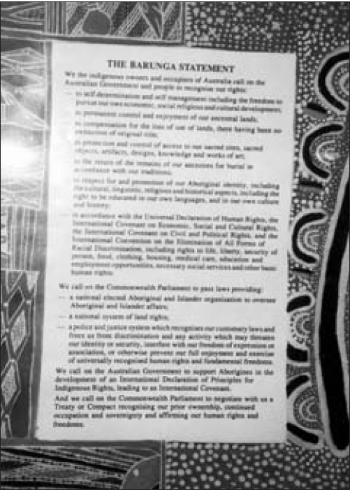 A photo of The Barunga Statement written on a beautifully engraved piece of wood.