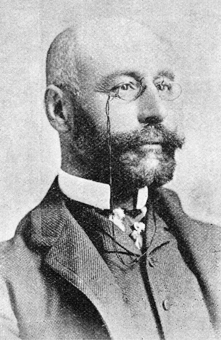 Englehart was a major figure in establishing Imperial Oil. In this formal photo he is shown hatless and balding, with a Van Dyke beard and monocle, celluloid collar, and a suit with vest.