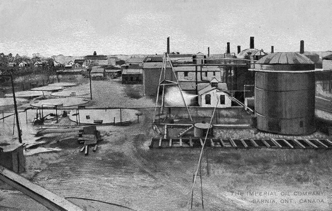 Sarnia, Ontario became the site of Imperial Oil’s largest refinery in the early 1900s. This photo from a postcard shows a petroleum distillery in the foreground and various storage buildings behind it.
