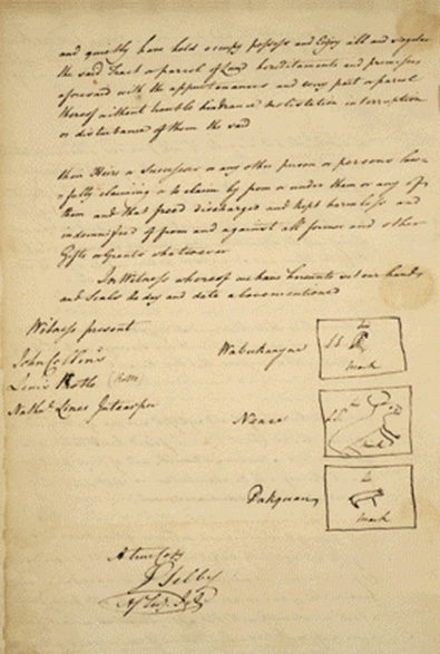Colour photograph. Photo of a yellowed historical document. There are two paragraphs of text at the top of the page, and signatures at the bottom. The signatures on the bottom right are accompanied by sketches of animals representing Doodems.