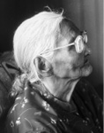 Black and white photograph: Photograph of a woman in profile wearing glasses and a patterned shirt