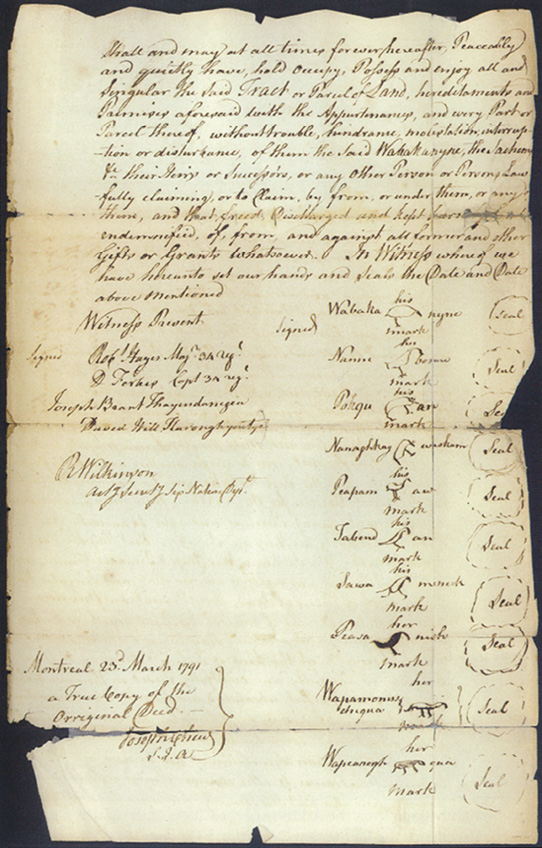Colour Photograph. Photo of a yellowed copy of an original document. This has a block of cursive text at the top, and the bottom half of the document is filled with signatures and Doodem marks.