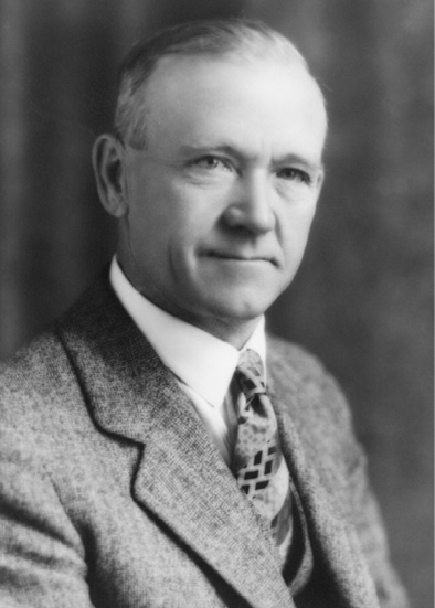 Figure 1-1 “William Stewart Herron” Black and white studio photograph of William Stewart Herron dressed in a three-piece suit and tie with a white collared dress shirt.