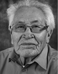 Black and white photograph: Portrait of a man wearing glasses and a collared shirt. 