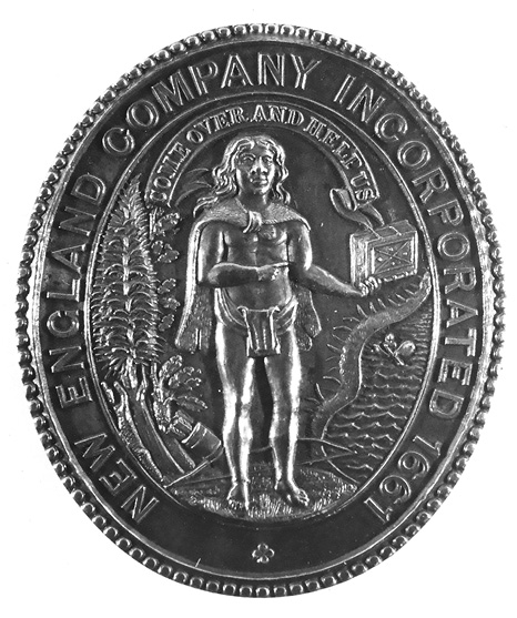 Black and white photograph: Oval-shaped metal medallion with a decorative edge that reads “New England Company Incorporated 1661.”  In the middle, an Indigenous man holding up a book is pictured, with a banner above him that reads “COME OVER AND HELP US.” Behind the man there are various nature items such as water and trees.
