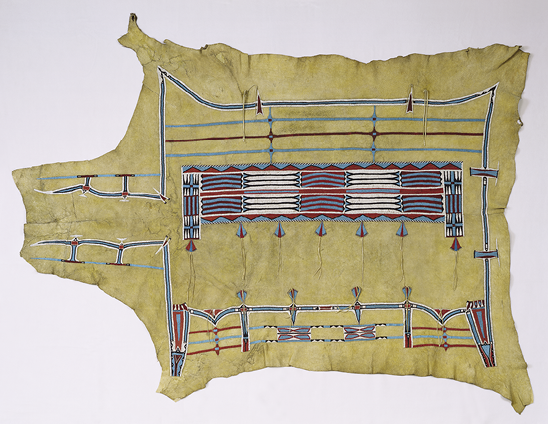 Pattern in dark blue, turquoise, red, and white on a yellowing animal hide. The lines value follow the square of the body leading into the neck. 