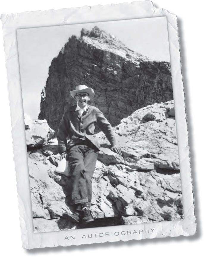 A photograph shows a man wearing a coat and a hat with specks, sitting on a rock. An autobiography.