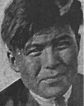 Black and white photograph: An old photograph of a man with short hair – the photo appears to have been cropped from a larger photograph. 