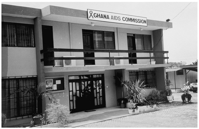 A black and white photograph showing the façade of the Ghana AIDS Commission Headquarters in Accra. It is a two storey building.