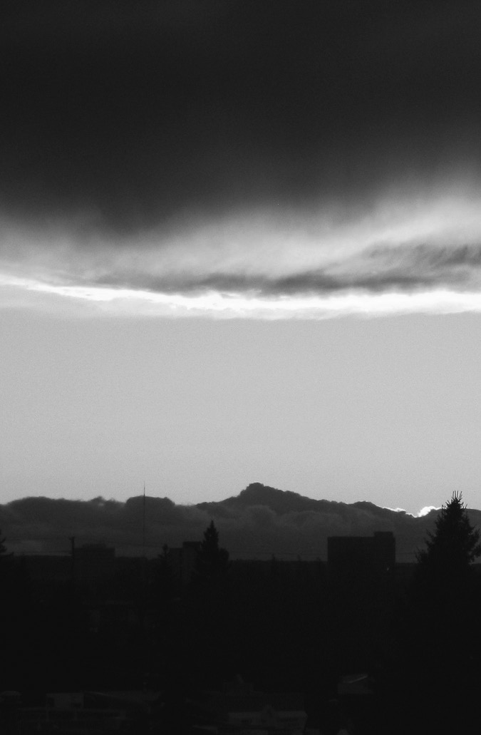 Dark clouds above a forest area. 