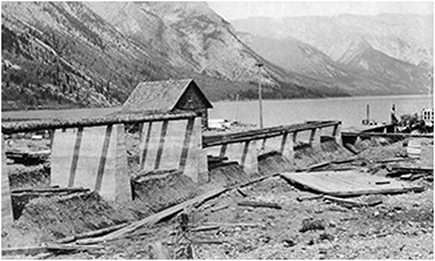A dock being built at Lake Minnewanka. There are mountains in the background.