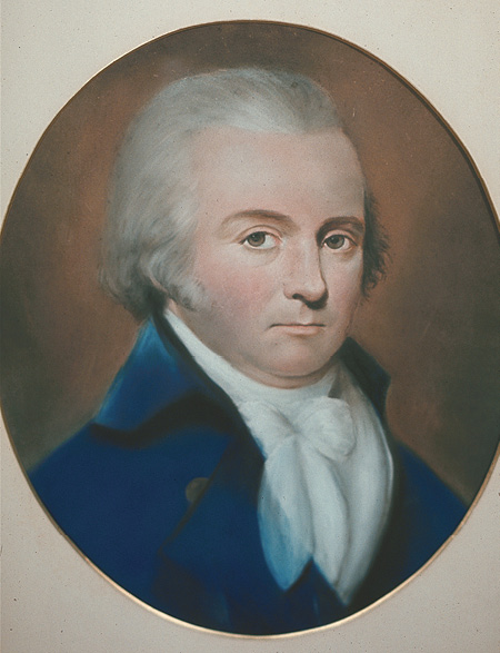 Colour painting. Portrait of a middle-aged white man, looking forward. He is wearing a white shirt with a white cravat at the neck and a blue jacket. He has grey sideburns and his hair is brushed back and covers his ears.