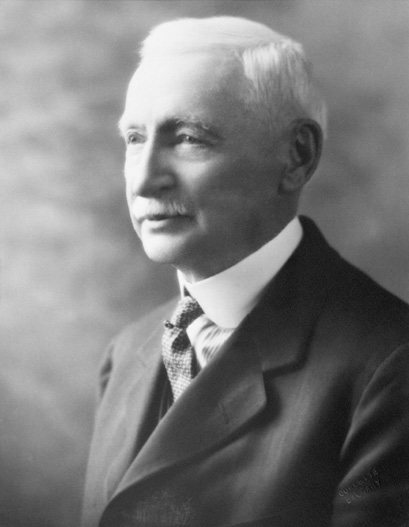 Figure 1-3 “Archibald Wayne Dingman” Black and white studio photograph of Archibald Wayne Dingman, wearing a sharp-looking suit, white collared shirt and tie.