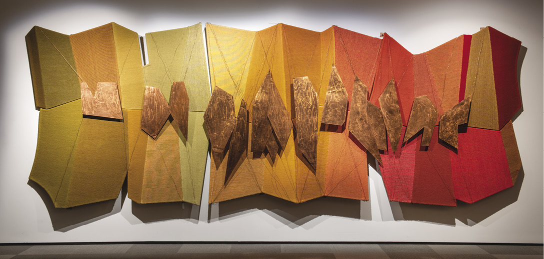 Photo: yellow-orange-red panels forming a kind of accordion with mounted pieces of copper along the middle joint.