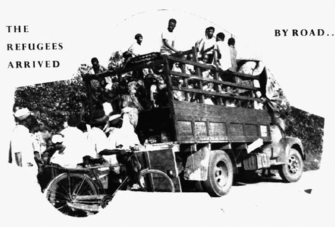 A black and white photograph shows people traveling in a truck and few are following the truck by foot and bicycle.