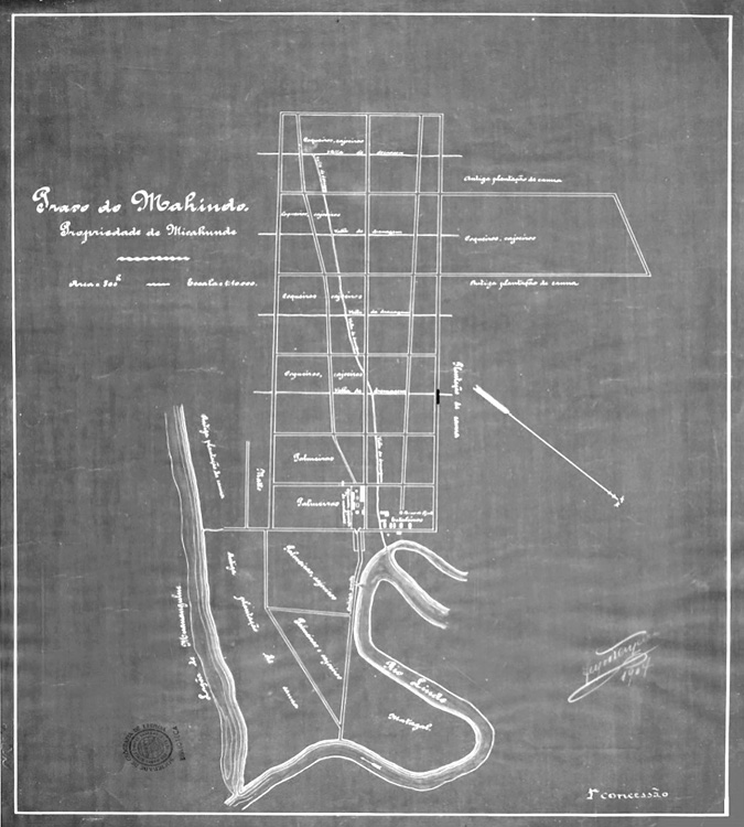 Black and white map. Hand drawn blueprint style map showing a settlement along a river. The river runs to the south of the settlement, which is drawn up in an approximate grid pattern. Some blocks of the grid are labelled.