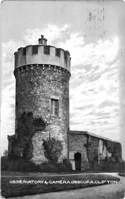 Black and white photograph, black and white postcard depicting an old stone building with a tall, round, stone tower, with a crenellated top; the postcard has the caption “Observatory and Camera Obscura Clifton” written at the bottom.