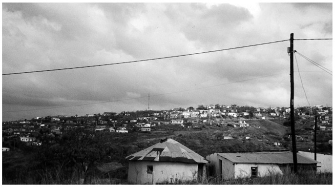 A black and white photograph showing the wide angle view of Folweni Deuse urban informal settlement in Sobonkhona Makhanya TA.
